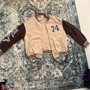 Brown jacket with snake design on one sleeve. Size Small